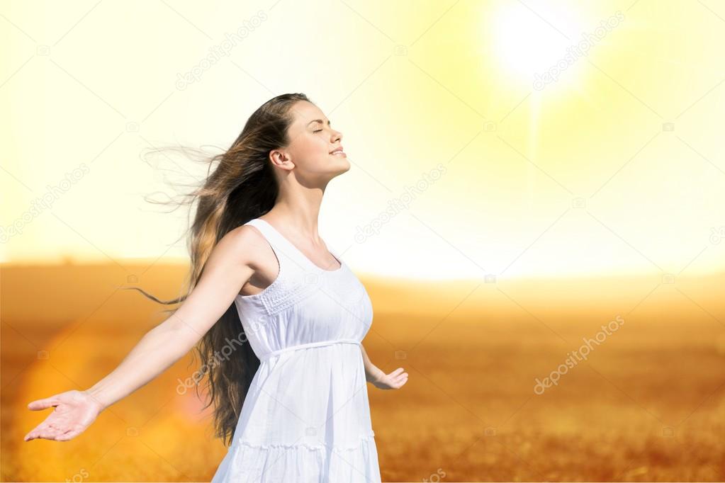 woman on field under sunset light