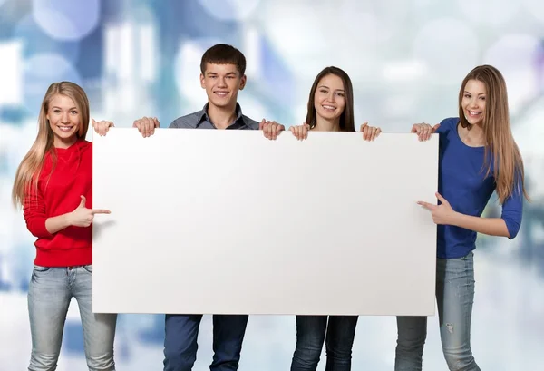 Students with blank sign — Stock Photo, Image