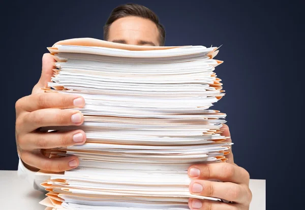 Businessman with stack of papers — Stock Photo, Image