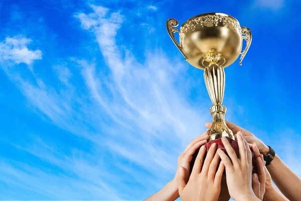 Hands holding golden trophy — Stock Photo, Image