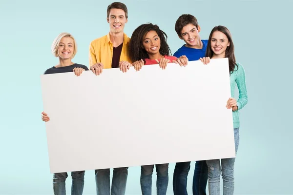 Friends displaying white placar — Stock Photo, Image