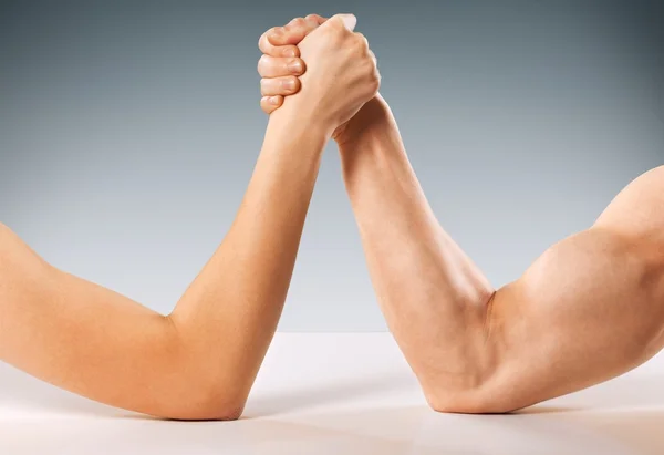 Man and woman doing arm wrestling Royalty Free Stock Images