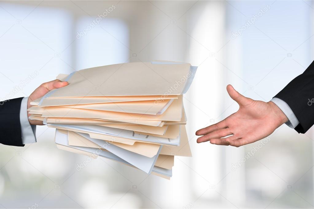 hands of businessmen holding documents