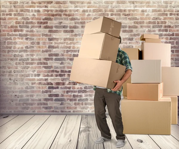 Lots of cardboard boxes and man — Stock Photo, Image