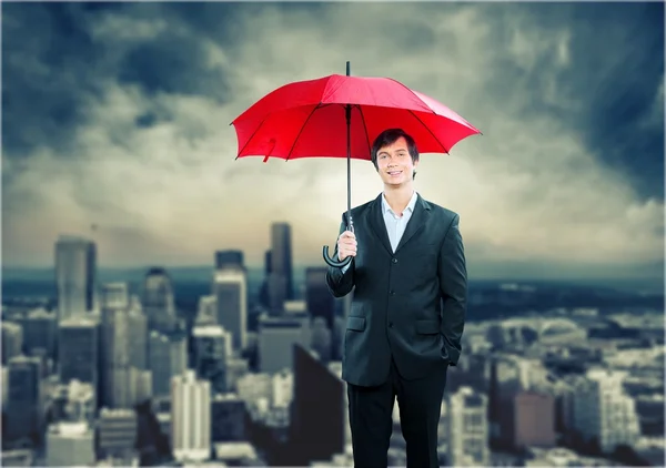 Happy businessman with umbrella — Stock Photo, Image