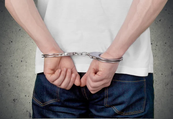 Man in handcuffs behind his back — Stock Photo, Image