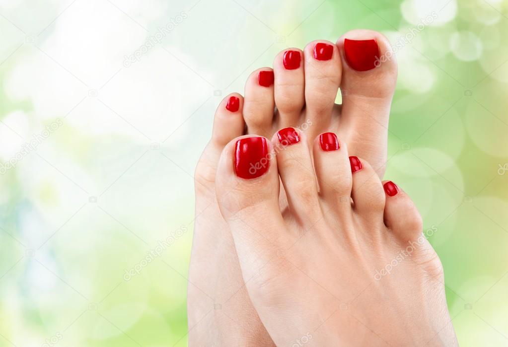 Beautiful female legs with red pedicure