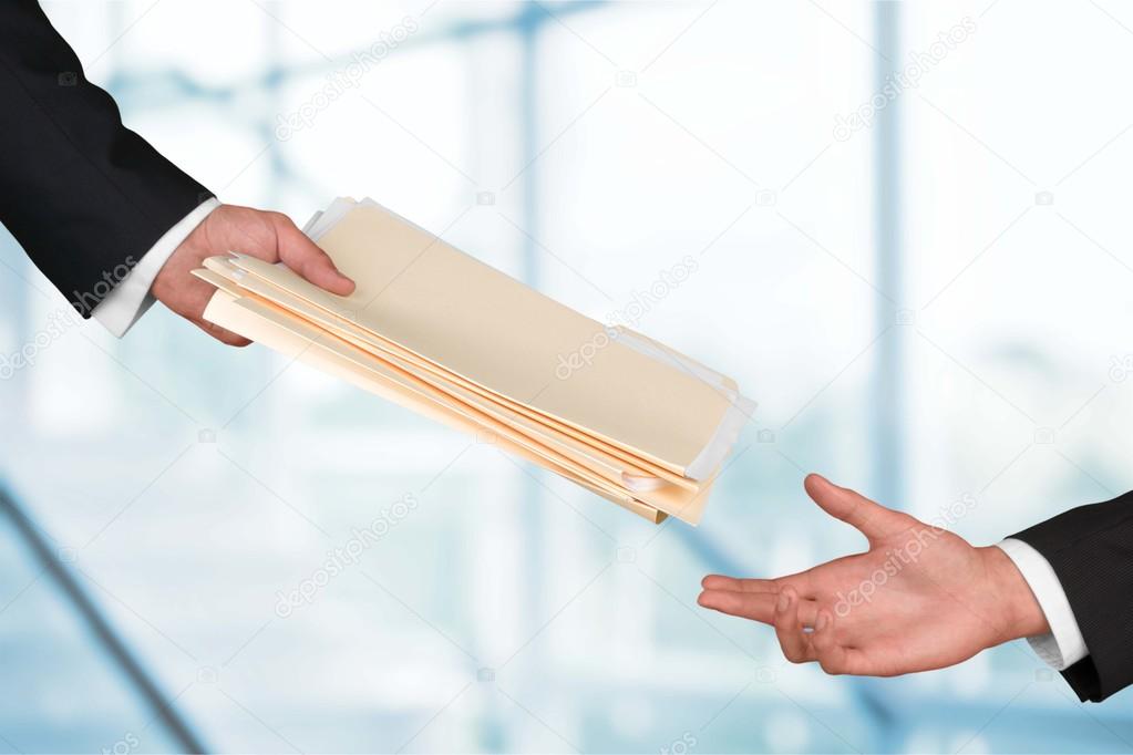 hands of businessmen holding documents