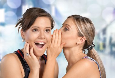 Woman revealing secret to her friend clipart