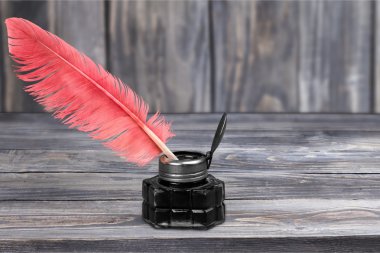 Feather quill pen and glass inkwell  clipart