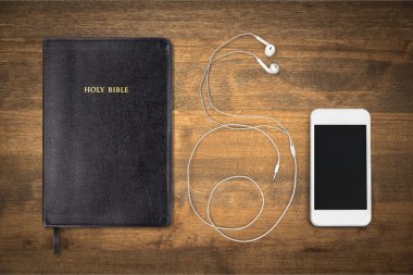 Holy Bible book and smartphone  clipart