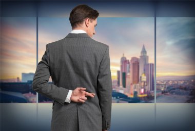 Businessman with his fingers crossed clipart