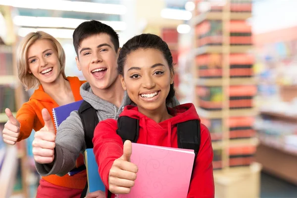 Students gesturing thumbs up — Stock Photo, Image