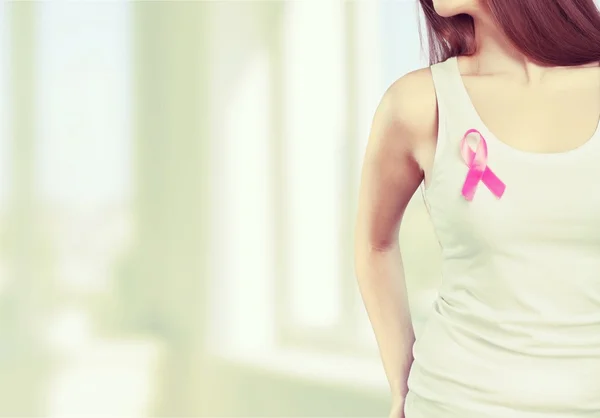 Woman chest with pink badge — Stock Photo, Image