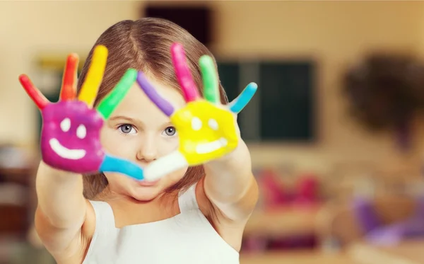 Cute little girl with colorful hands — Stock Photo, Image