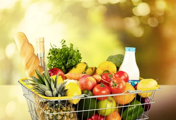 Shopping cart full with various groceries — Stock Photo, Image