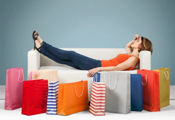 Woman lying on the sofa  after shopping
