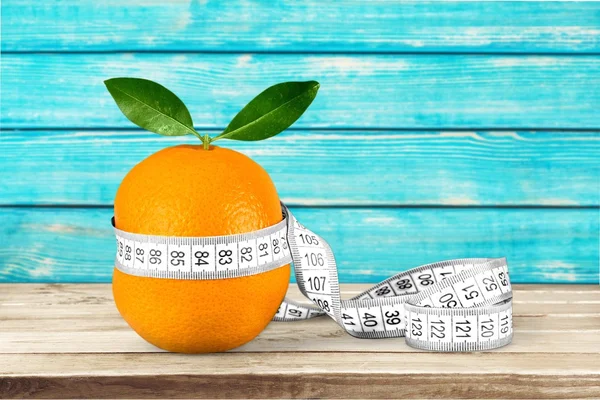 Orange with measuring tape — Stock Photo, Image