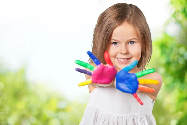 Cute little girl with colorful hands — Stock Photo, Image