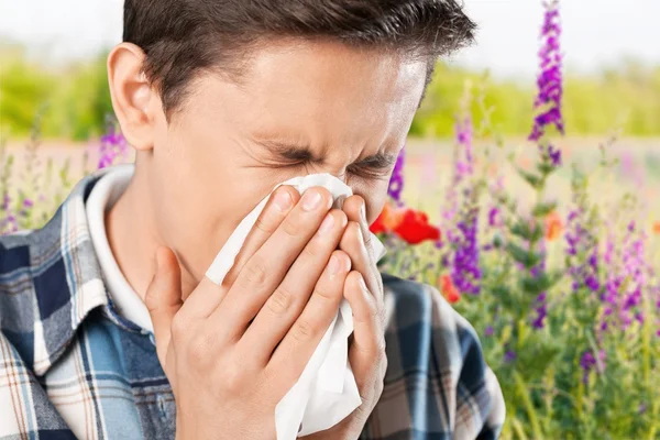 Knappe man zijn neus waait — Stockfoto