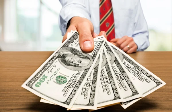 Hand with dollars  on  background — Stock Photo, Image