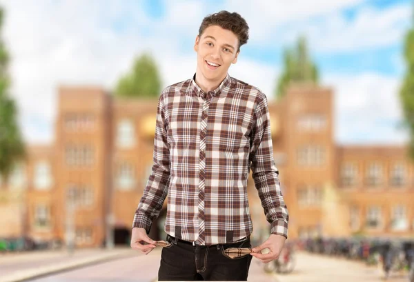 Young student showing empty pockets — Stock Photo, Image