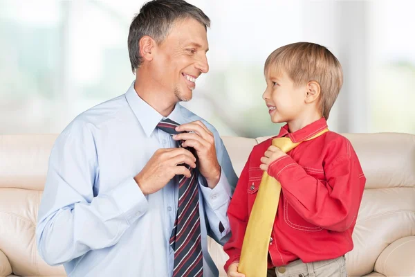 Menino feliz e seu pai amarrando gravatas — Fotografia de Stock