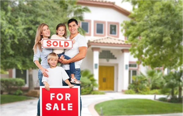 Happy Family with for sale sign — Stock Photo, Image