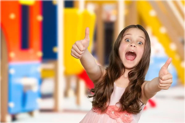 Ragazzina gesticolando pollici in su — Foto Stock