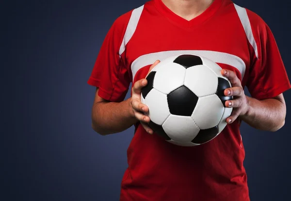 Soccer player is holding ball — Stock Photo, Image