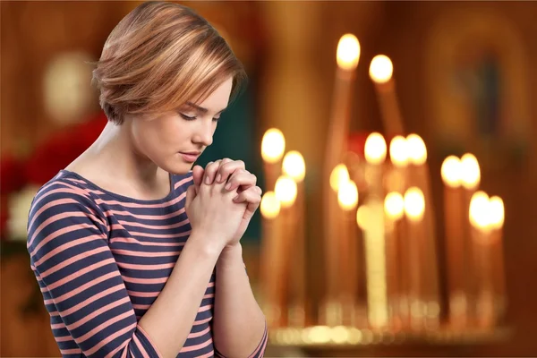 woman praying in a church