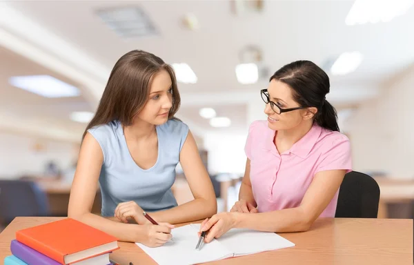 Mother helping happy daughter with homework — Stock Photo, Image
