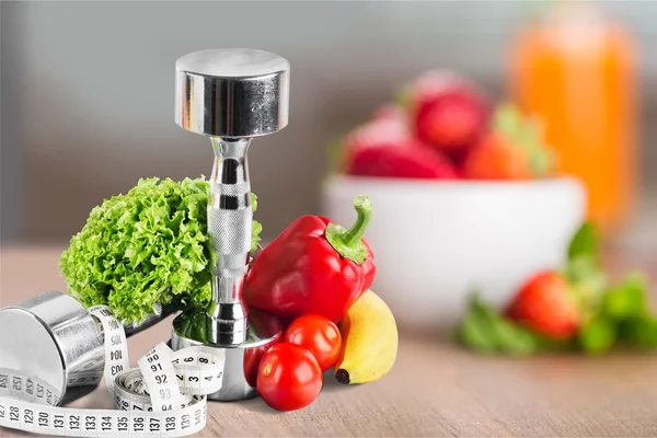 Sombrillas con agua, cinta métrica y frutas — Foto de Stock