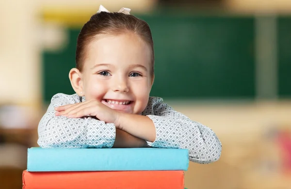 Cute little schoolgirl with books — Stock Photo, Image