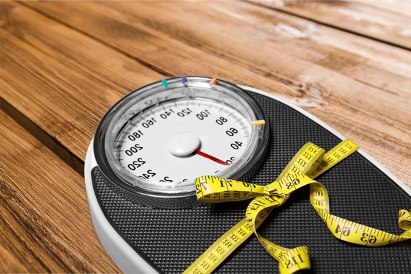 Bathroom scale with a measuring tape — Stock Photo, Image