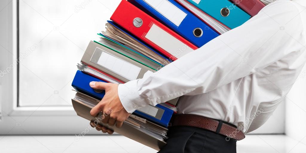 office worker holding binders