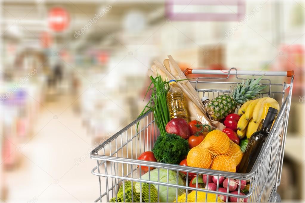 shopping cart full with various groceries