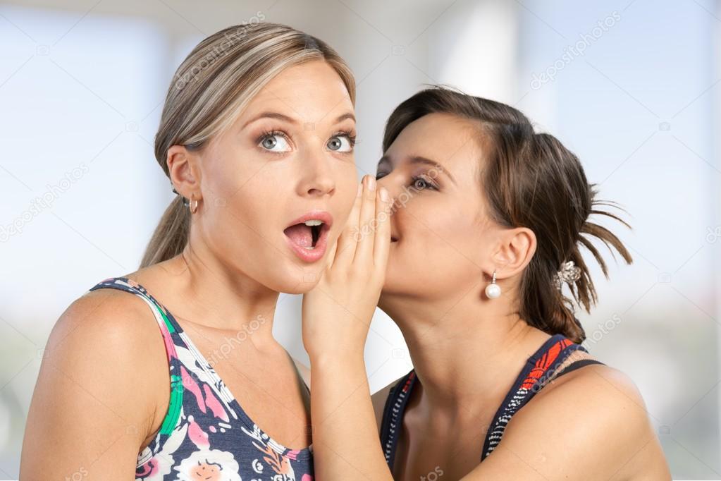 Woman revealing secret to friend