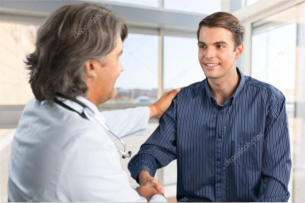 male patient shaking doctors hand