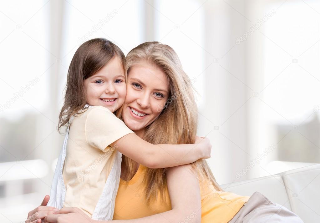 Mother and daughter hugging  