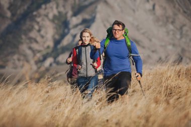 A group of tourists Man with big backpack hiking up adventure in mountain. Travel leisure activity concept