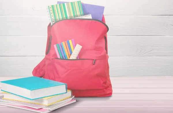 Colored school backpack with school stationery