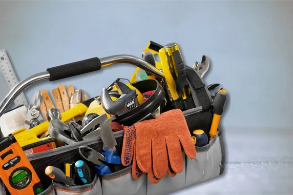 Tool belt with tools on wooden background