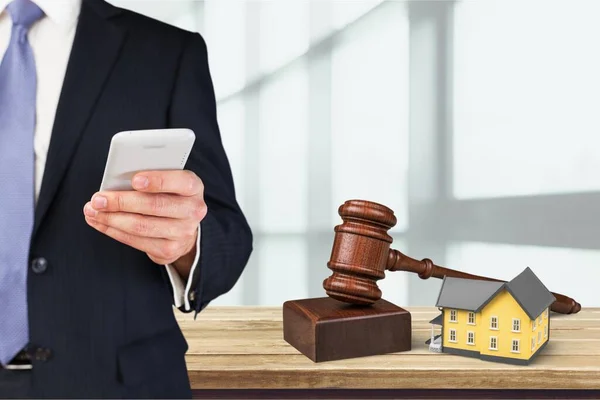 Cropped view of Businessman holding the phone standing in front the major cities