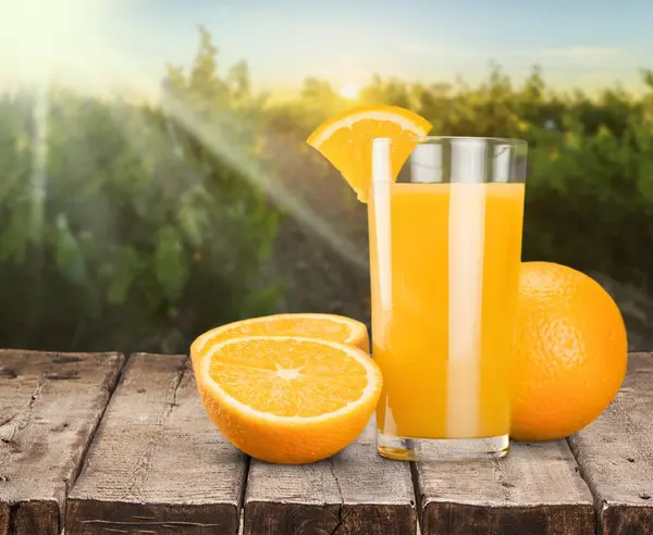 Doğal arkaplanda bir bardak lezzetli portakal suyu