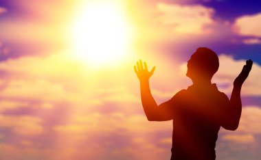 Tanrı 'ya dua eden kişi güneş ışığıyla donatılmış.