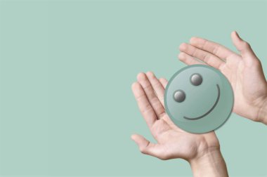 Yeşil bir gülümseyen yüz, olumlu düşünce, zihinsel sağlık konsepti.