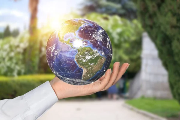 Woman holding earth globe in her hand, save the earth and energy concept.