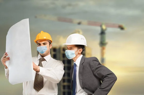 Construction Site Engineer And Building Inspection holding documents.