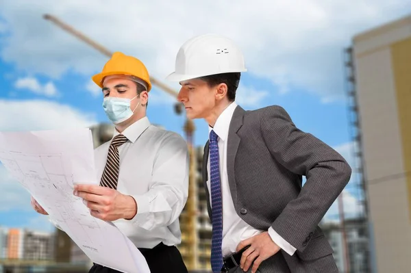 Construction Site Engineer And Building Inspection holding documents.